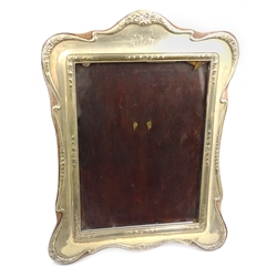  Silver freestanding photograph frame, raised garland decoration, Chester 1915, mahogany back, 31cm  