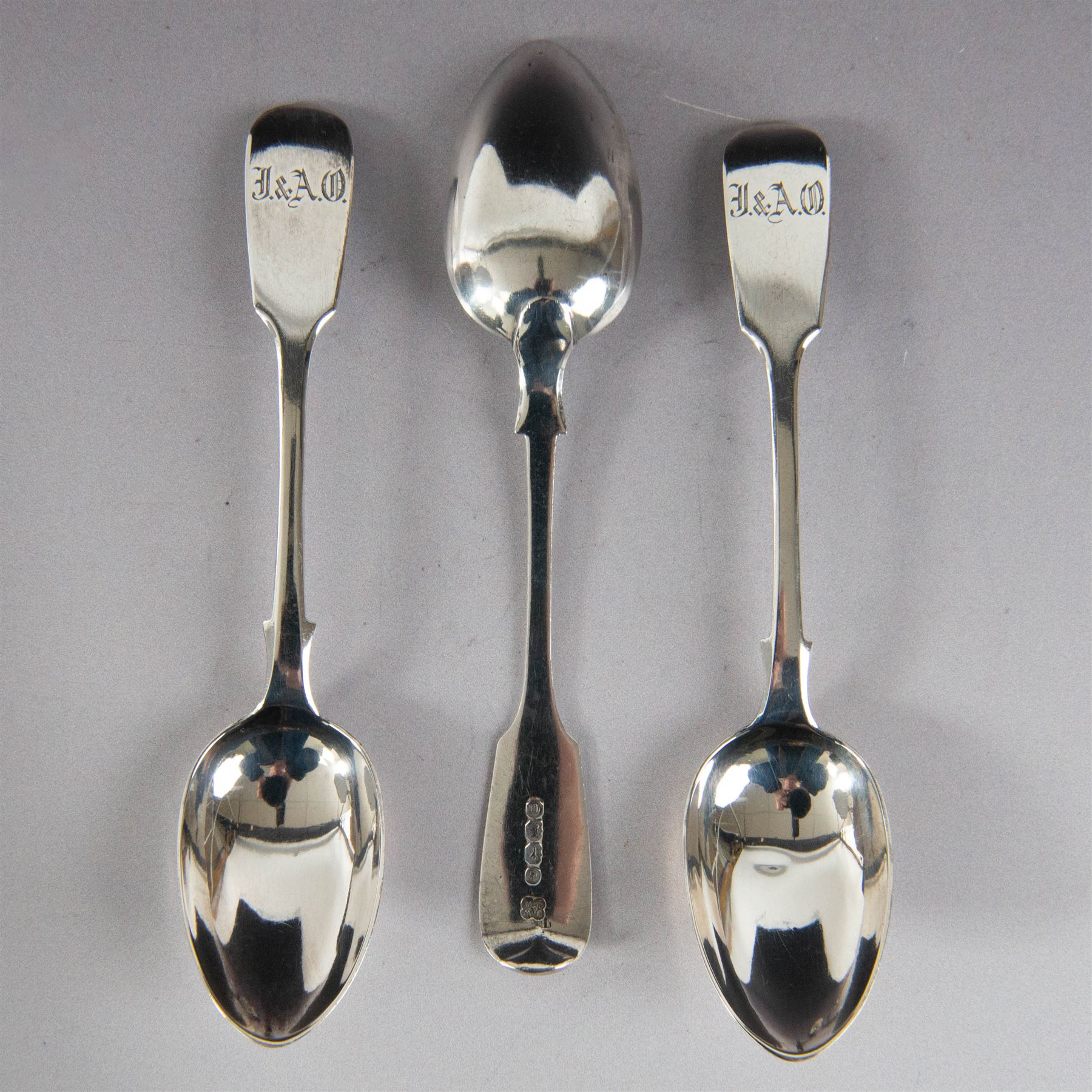 Set of twelve Victorian Exeter silver Fiddle pattern teaspoons, all with engraved initials to terminal, hallmarked Josiah Williams & Co, Exeter 1860, contained within tooled leather case with burgundy silk and velvet lined interior
