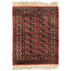  Small peach ground Bokhara rug, decorated with two rows of Gul motifs 