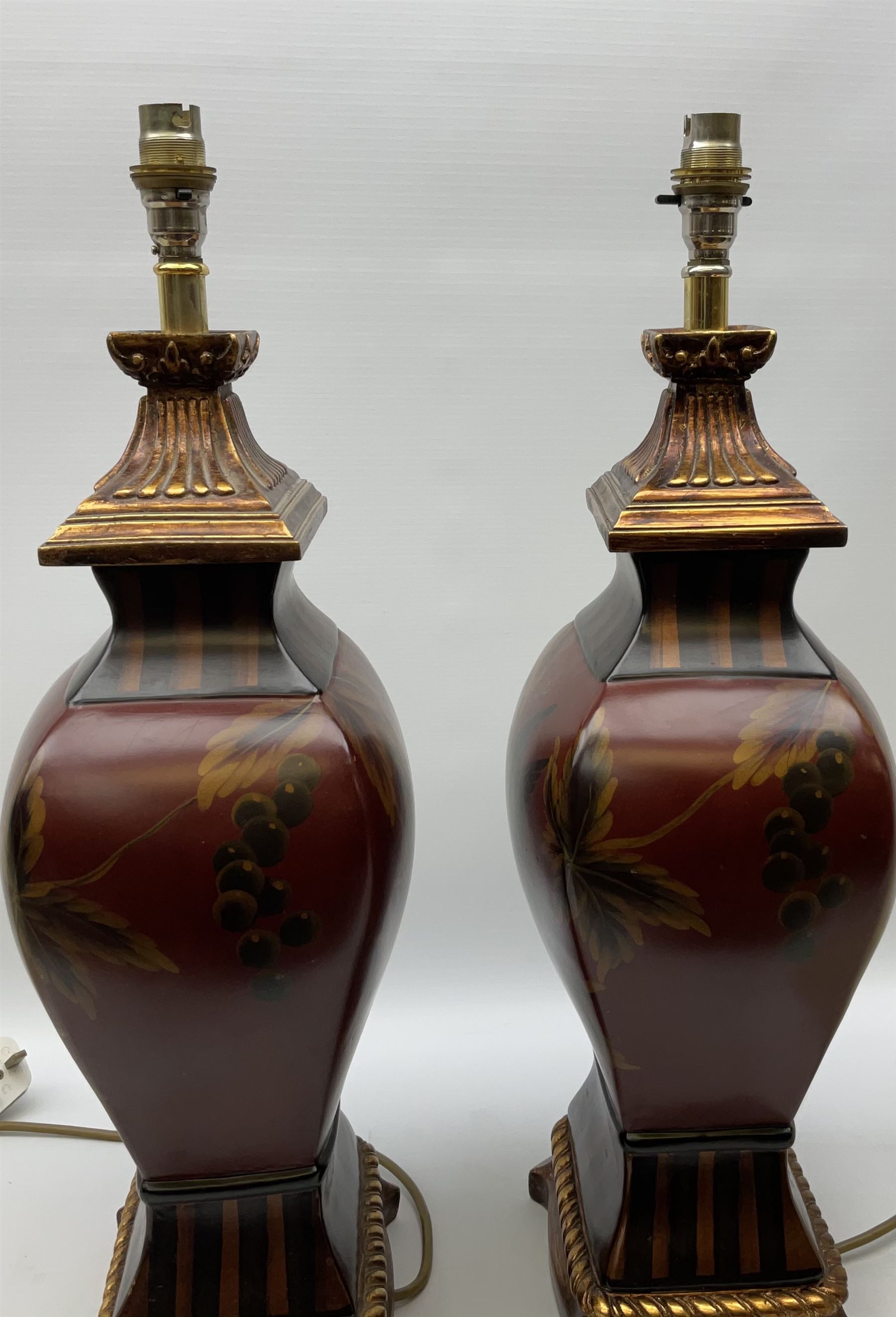 Pair Oriental table lamps decorated with birds in a tree with fruit, on a red ground with a gilded base together with cream lampshades H57cm, without lampshade. 