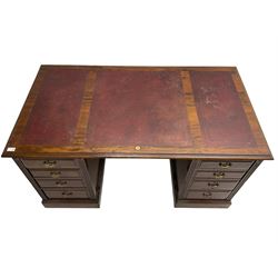 Edwardian mahogany twin pedestal desk, rectangular top with triple inset maroon leather writing surface, fitted with eight graduating drawers flanked by reeded uprights, on skirted bases