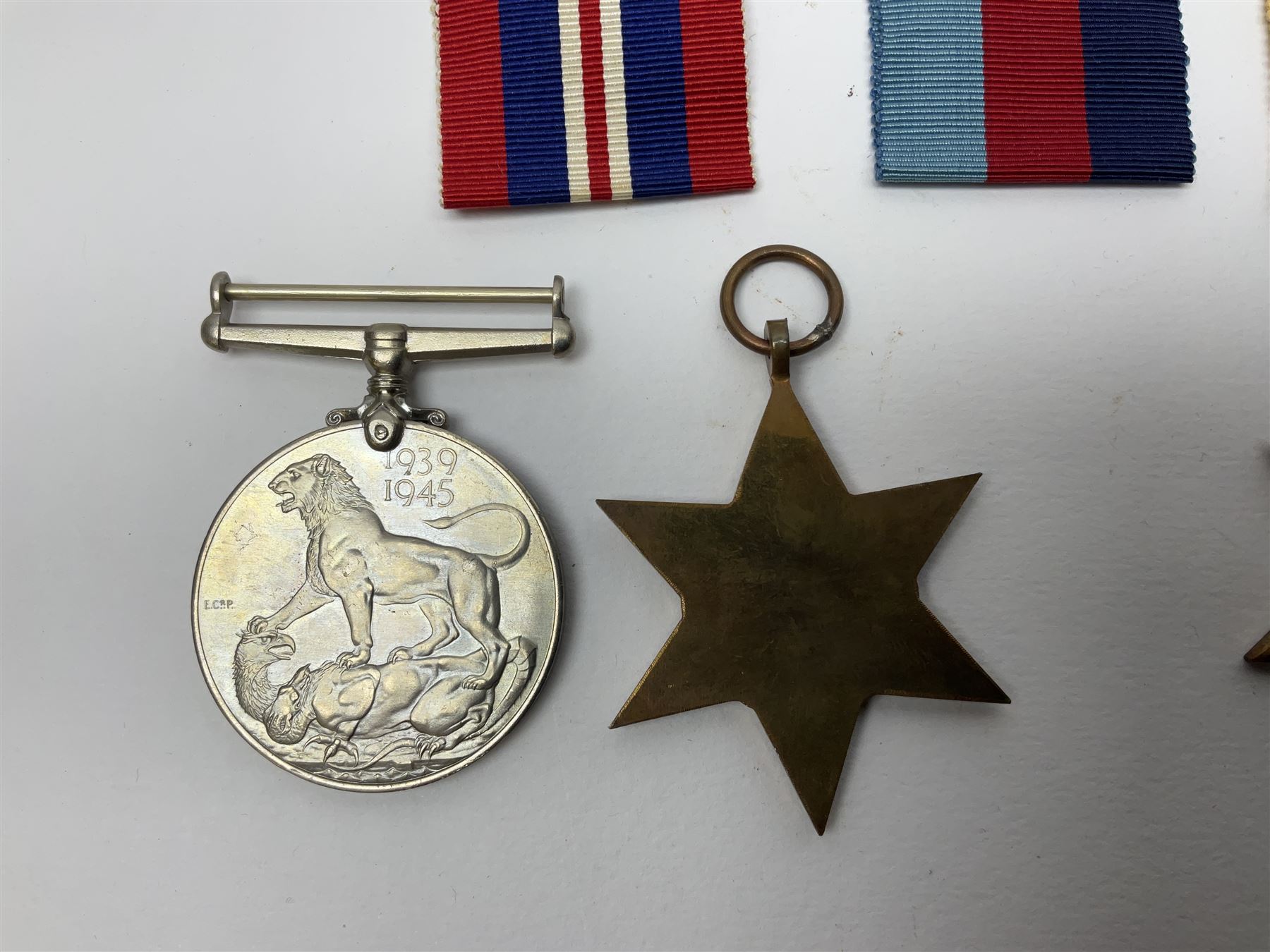 Twelve WW2 medals comprising four 1939-1945 war medals, four Defence medals, three 1939-1945 Stars and Africa Star; all with ribbons; some as groups in two issue boxes with slips