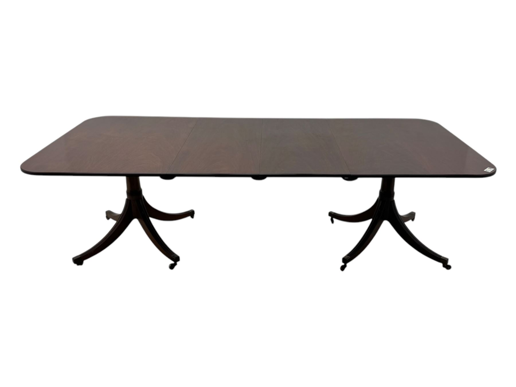 Regency design mahogany twin pillar dining table, two additional leaves, on turned supports with four out-splayed supports 