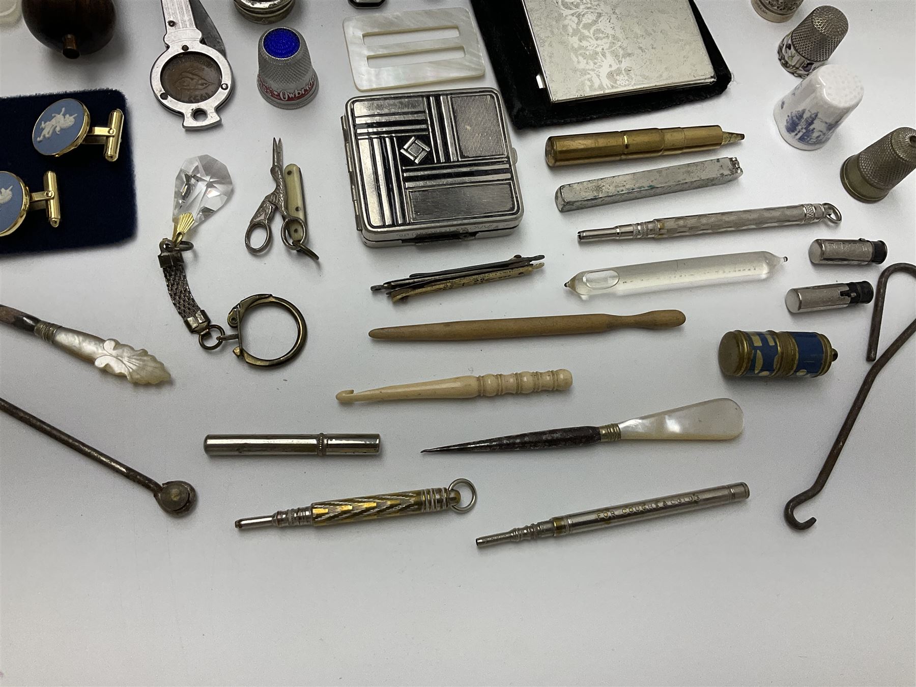 Pair of Wedgewood jasperware unicorn cufflinks, silver handled part manicure set, enamel flip notebook, dolls leather gloves, Stratton compact, and a collection of sewing accessories including thimbles, button hooks, thimble holder, scissors etc 