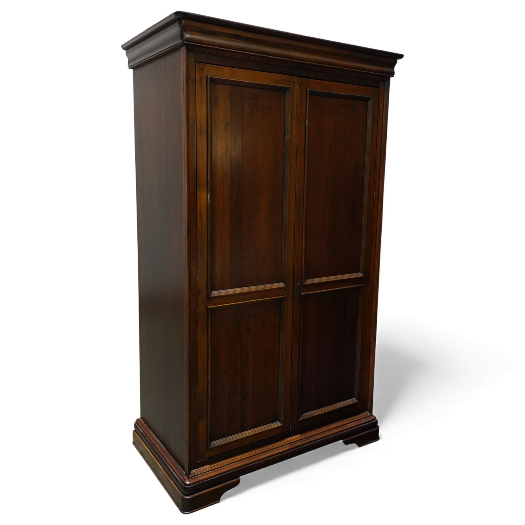 Willis & Gambier - French cherry wood double wardrobe, panelled front twin doors, internal wooden hanging rail below a shelf, raised on a moulded plinth base 