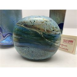 Two Isle of White glass vases, by Alum Bay Glass, both with blue swirl design upon an iridescent mottled blue/green ground, together with a Gozo Glass vase of pebble form, with similar design, H12cm