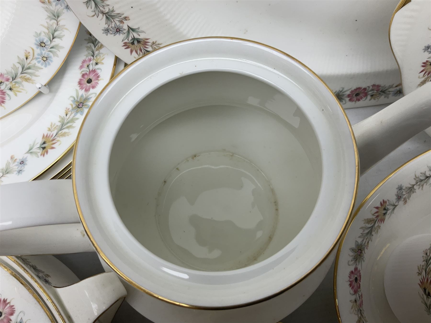 Royal Albert Paragon tea and dinner service for twelve decorated in the Belinda pattern, comprising fourteen saucers, twelve teacups, thirteen side plates, teapot, sauce boat and stand, salt and pepper shakers, two jugs, sucrier, twelve dinner plates, twelve smaller plates, two lidded tureens, twelve bowls, twelve smaller bowls, cake plate, oval plate and oval dish (100)