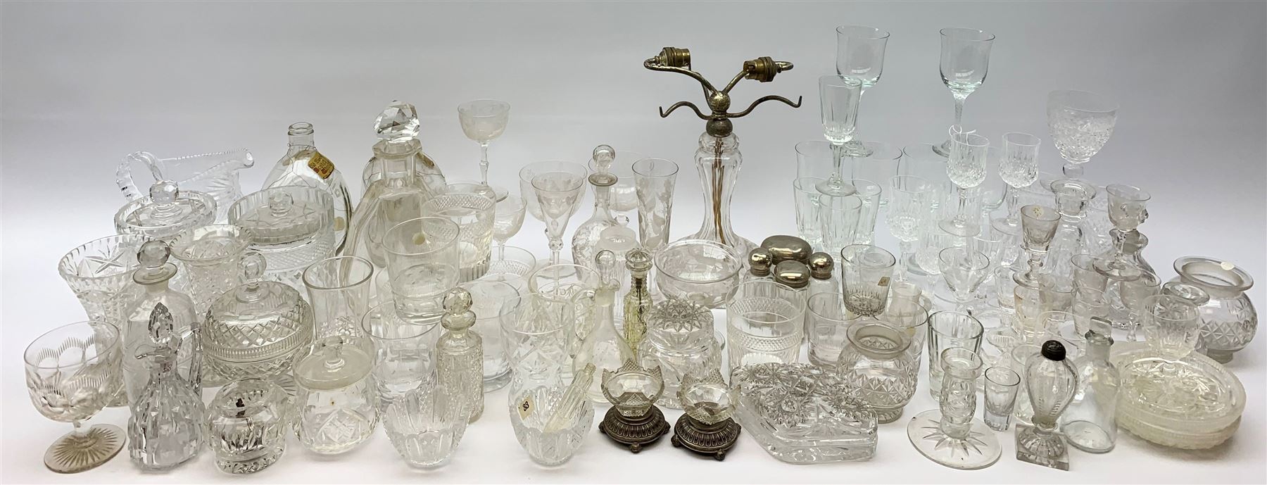 A number of Victorian tumblers and Edwardian drinking glasses, together with a large quantity of other later glassware, to include a glass table lamp base, drinking glasses of various forms, a number with cut decoration, other assorted cut glass including jug, vases, jars and covers, etc. 