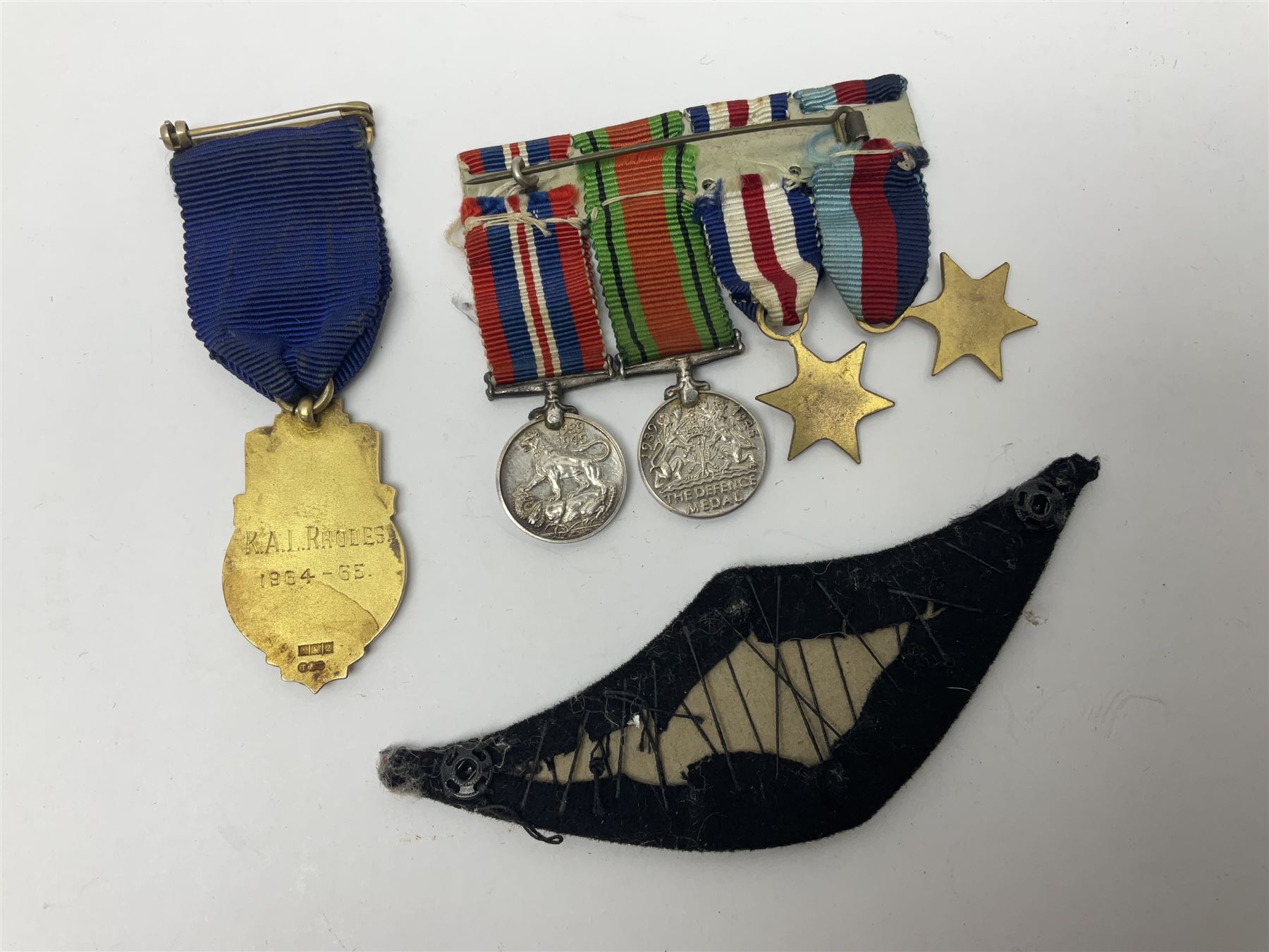 Collectables, to include enamelled Gothic Florin, Hull Rudston and Preston 1811 one shilling six pence token, silver gilt Hull Airedale Terrier Club fob, silver and tortoiseshell badge inscribed East Yorkshire beneath Yorkshire Rose, polychrome enamel buckle, mother of pearl badge carved with rose and tiger and inscribed York & Lancaster, etc.