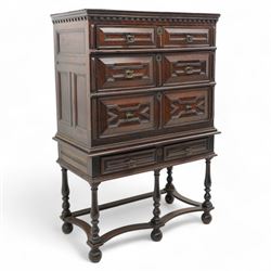 17th century oak chest on stand, moulded cornice over block work frieze, the upper section fitted with three long drawers each decorated with applied geometric mouldings and faceted panels, panelled sides with moulded frame, the stand fitted with two drawers, on five turned supports united by plan flat stretchers, terminating to turned feet