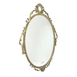 Ornate brass wall mirror with oval plate, L78cm