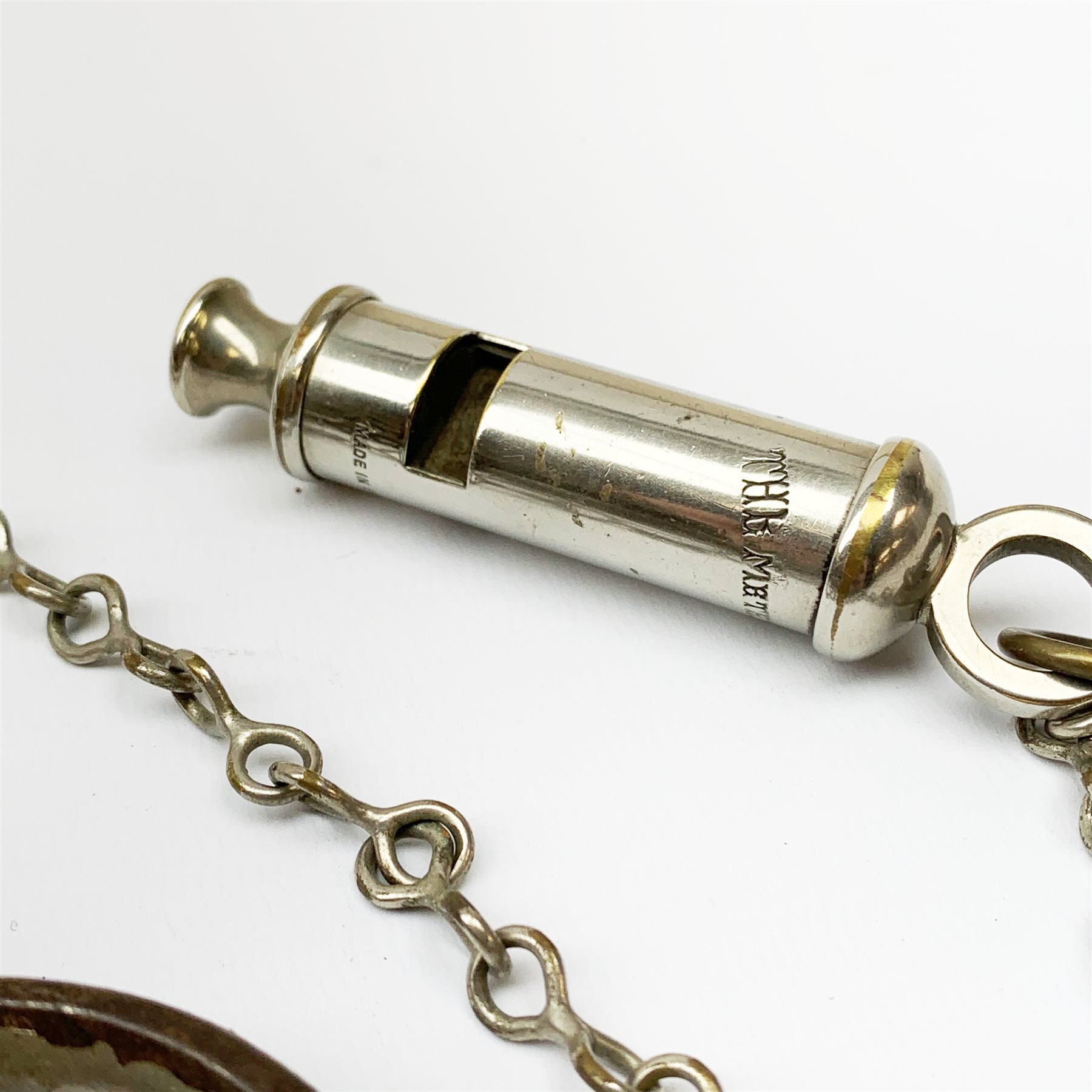 Pair of 1920's Hiatt nickel plated handcuffs marked 'Warranted Wrought' with screw-in key and a 'Metropolitan' whistle