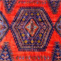 West Persian Veis hand-knotted rug, coral red field decorated with a series of bold geometric lozenge medallions in shades of indigo and sky blue surrounded by angular tribal motifs and stylized animal and plant forms framed by a deep indigo border of geometric ornament and multiple guard stripes, cotton fringe ends 