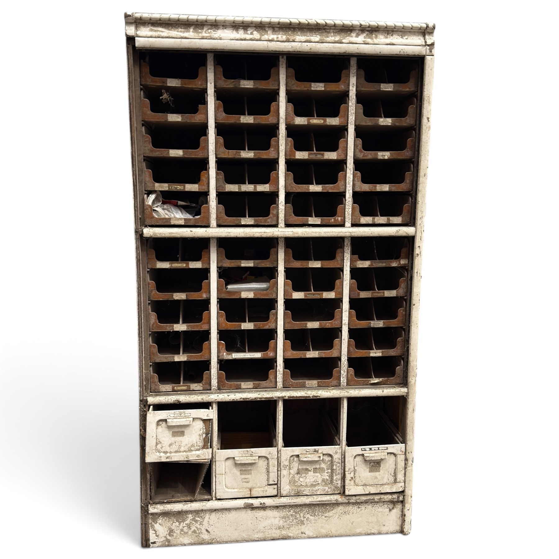 F Pollard & Co - late 19th century rustic haberdashery shop cabinet, fitted with an assortment of forty sliding trays, with drawers fitted to base, in antique white-painted finish
