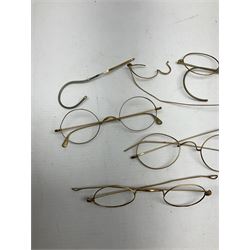 Quantity of 19th century and later gold spectacle frames, testing approx. 11ct and under, gross weight approx 44g, together with 9ct gold ring, the band hallmarked 375, weight 2.5gms
