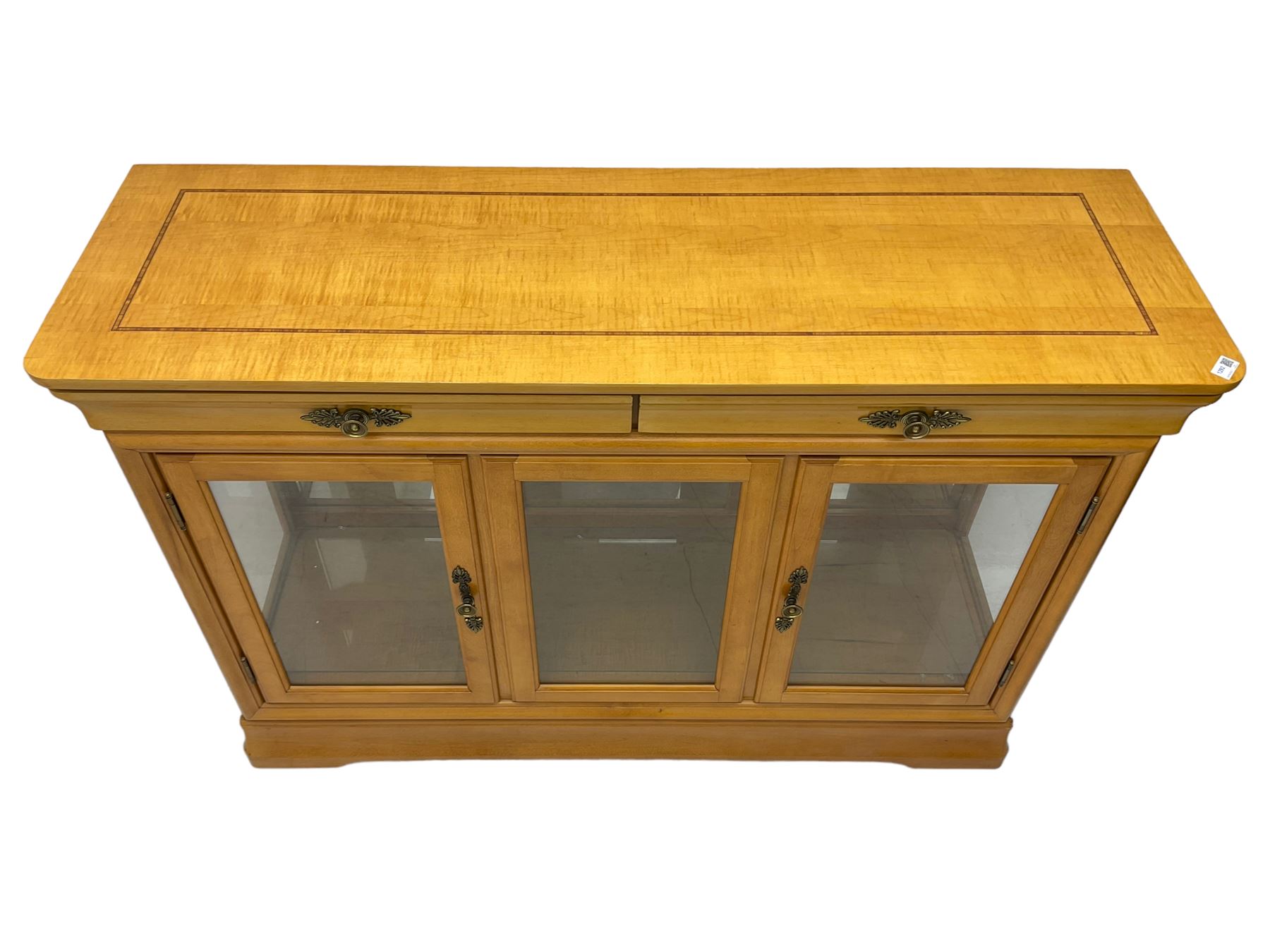 Yew wood sideboard, rectangular top with mahogany and ebony stringing, fitted with two drawers over three glazed cupboard doors enclosing glass shelves