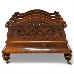  Victorian, walnut Canterbury- magazine rack with four fretwork upstands, drawer to base, standing on turned legs terminating in original castors. circa 1880