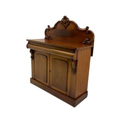 Victorian mahogany chiffonier side cabinet, raised shaped back with carved cartouche, single drawer over double cupboard, plinth base