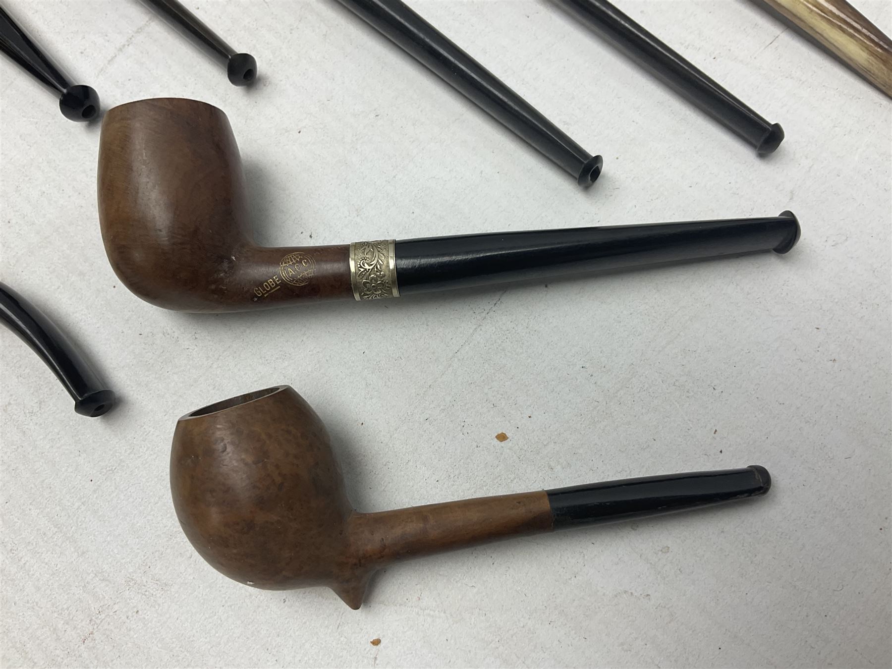 Collection of eight silver mounted pipes, comprising a briar wood Imperial ITC example with silver collar hallmarked A.W Birmingham 1903, horn handled example with silver collar hallmarked LB, probably Louis Blumfeld, Birmingham 1900, three examples marked B.W, one marked Globe A.O.C, Blumfeld's Best Briar pipe marked BBB and Riseagle example, together with two further pipes (10)