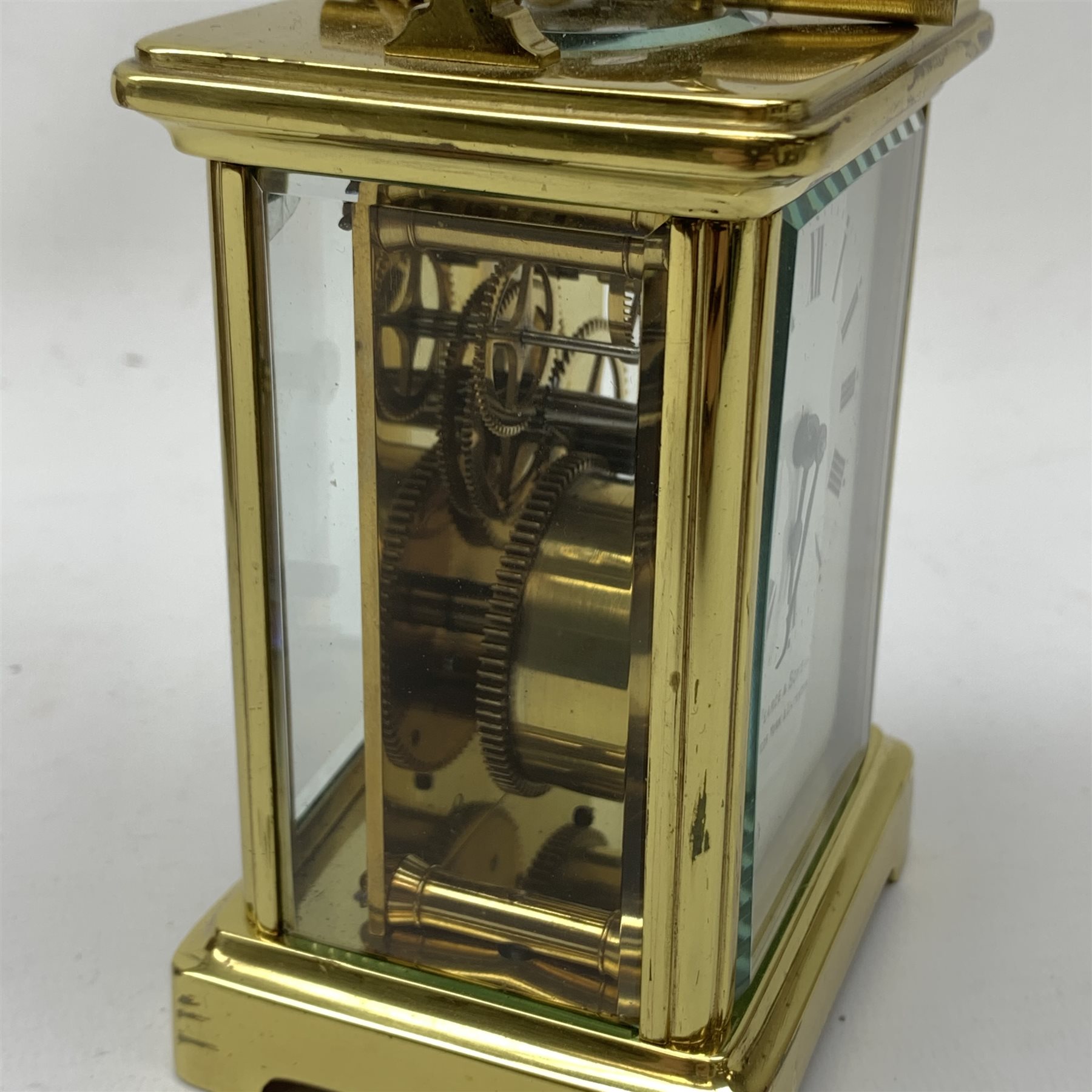 A brass cased carriage clock, the white enamel dial with black Roman numerals, marked Pearch & Sons Leeds, York & Leicester, including handle H14cm, in fitted case. 