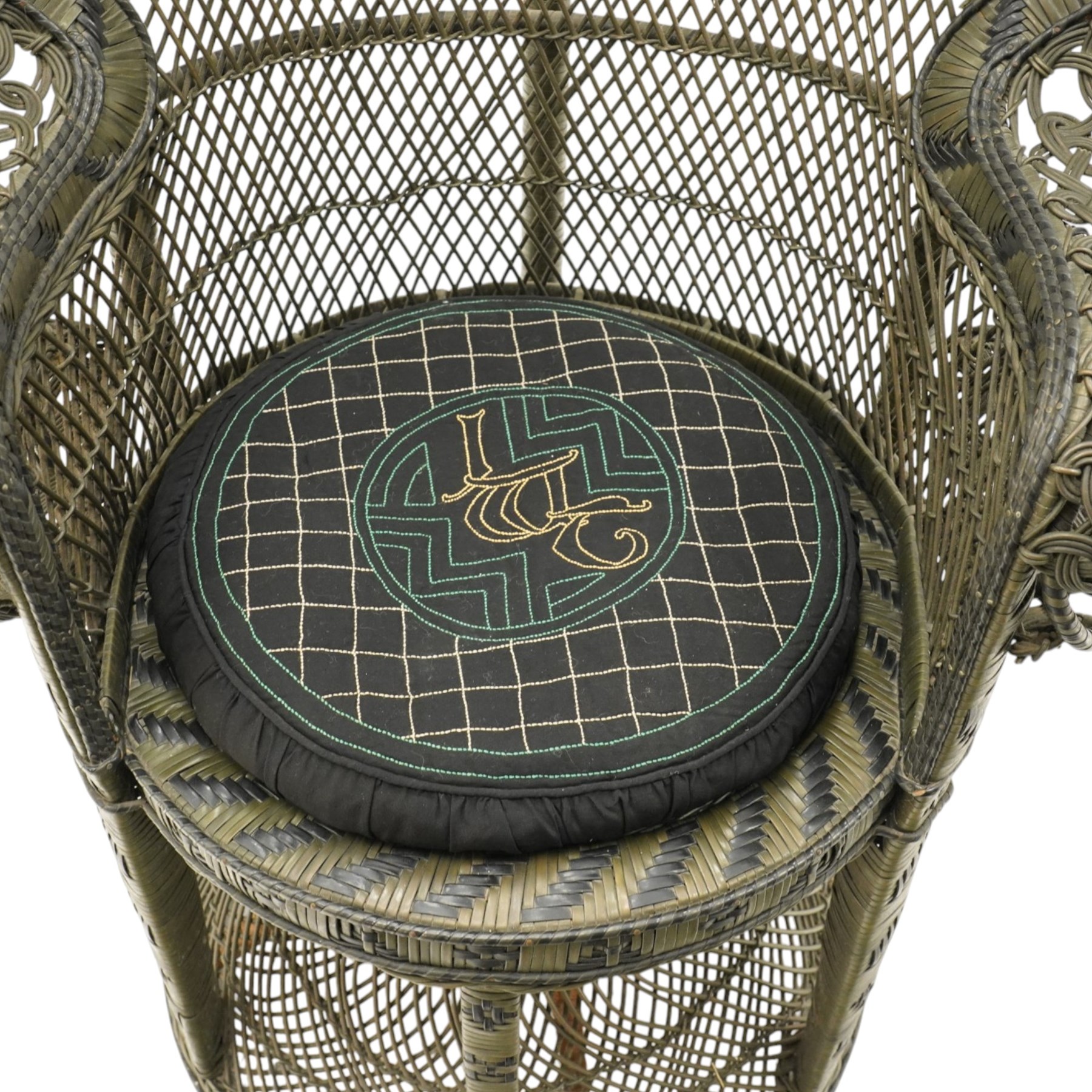 Mid-20th century wicker and rattan Peacock chair in unusual tones of dark olive and black, high fan back with a pieced and woven frame terminating to scrolled arms, with loose seat cushion