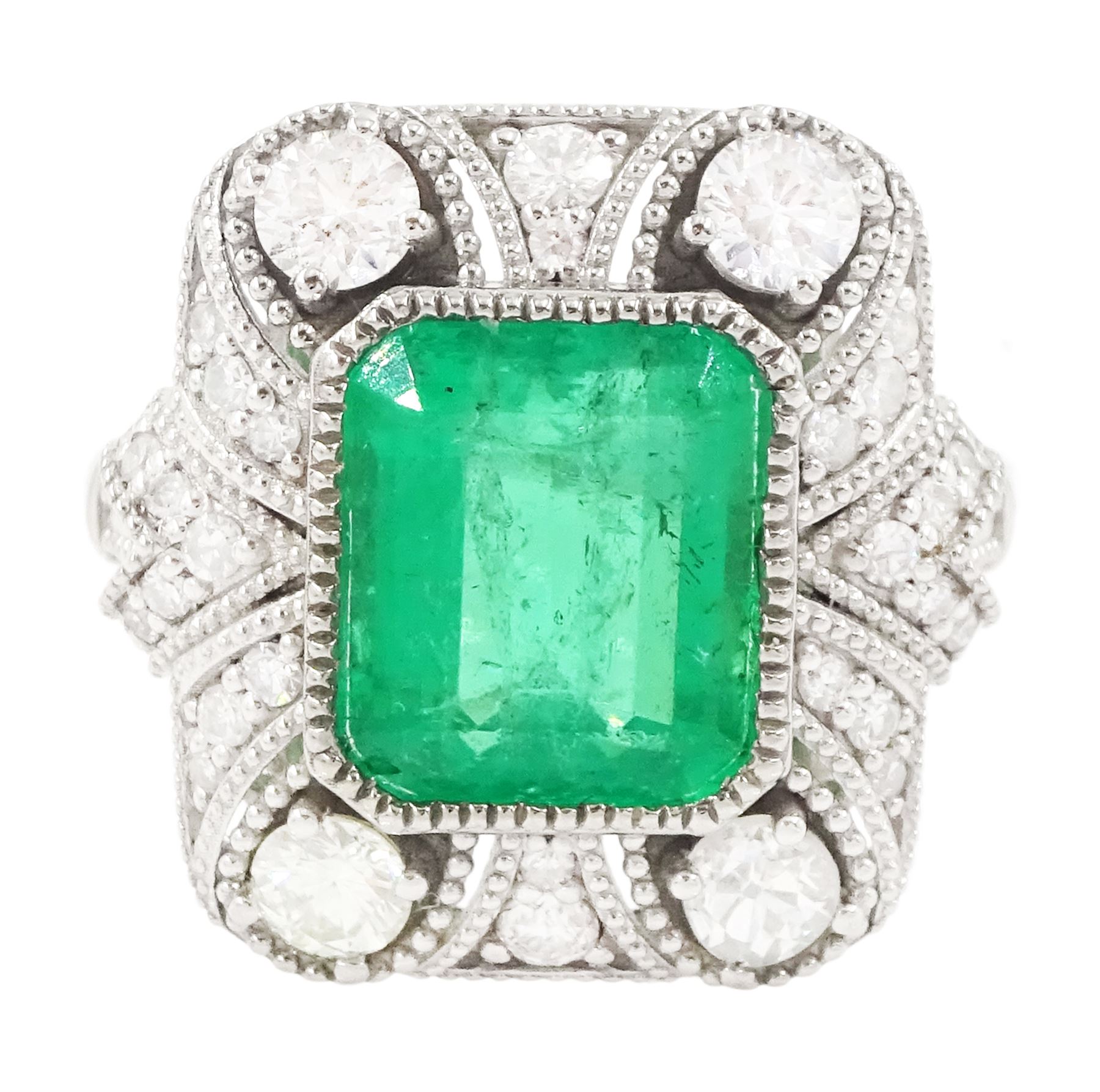 Platinum emerald and diamond cluster ring, single octagonal cut emerald of 2.52 carat, surrounded by milgrain set round brilliant cut and single cut diamonds, stamped PT950, total diamond weight 0.82 carat