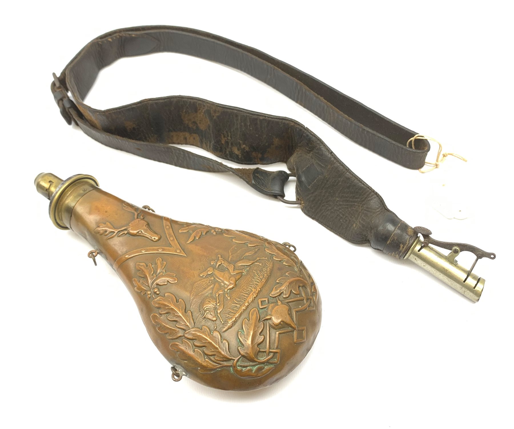 Victorian large copper powder flask embossed with a hunting scene within an oak leaf border with stag and fox heads, the nozzle marked 'Extra Quality Sykes Patent', fitted with four suspension rings H24cm; together with Victorian leather shoulder shot flask with Sykes nozzle L80cm (2)
