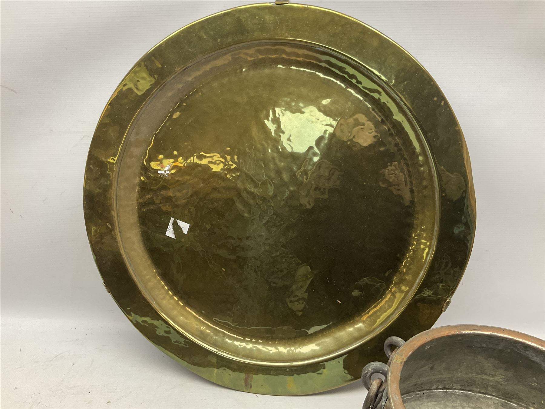 Copper pot with twin iron handles, large heavy planished brass charger and brass crocodile tray, charger D59cm