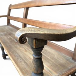 Early 20th century pine and oak bench seat, stained pine rail back frame with shaped oak arms