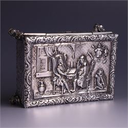 Victorian silver tobacco box, rectangular form, hinged lid embossed with a gaming scene, the body engraved with scrolls and flowers, upon four scrolling mask feet, hallmarked George Heath London 1885, H4.5cm, W10.5cm