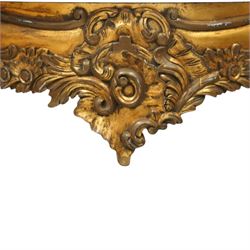 20th century Louis XV design giltwood console table, shaped white marble top over pierced and carved frieze with floral and foliate motifs, raised on cabriole supports united by X-shaped stretcher with central floral finial 