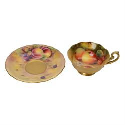 Royal Worcester fruit painted cabinet teacup and saucer, interior hand painted with apples, blackberry and cherries upon a mossy ground, the cup exterior and centre of saucer gilded, cup and saucer signed Rickells, each with puce coloured printed marks beneath, H7cm