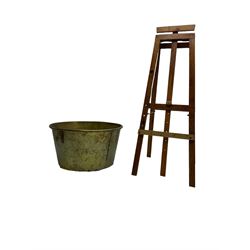 Large 19th century brass bucket or log store (D66cm, H42cm); together with a 20th century pine easel (H127cm)