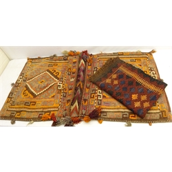  Kilim rug with geometric decoration on maroon ground, 103cm x 69cm and a Kilim saddle bag with Greek key pattern borders, fringe work and two lozenge shaped panels and fringing (2)  