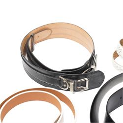 Collection of belts, including white Nike Golf leather belt with oval green and silver Nike swoosh buckle, white Nike leather belt in perforated pattern, black Aigner crocodile-embossed leather belt with large gold buckle, black Jaeger quilted leather belt with rectangular gold buckle, etc (10)