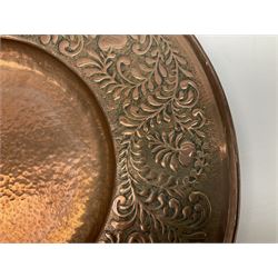 Arts and Crafts Keswick School of Industrial Arts copper charger, decorated with planished centre and repousse scrolling foliate tendrils to rim, D44cm