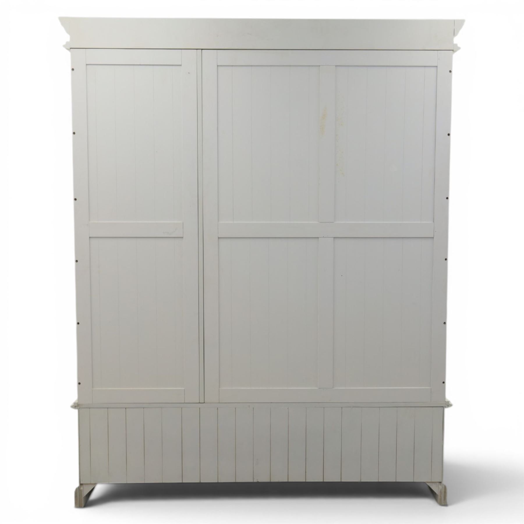 Modern white three door wardrobe, with two hanging section and shelving area, above a long drawer and a short drawer to the base, raised on a moulded plinth