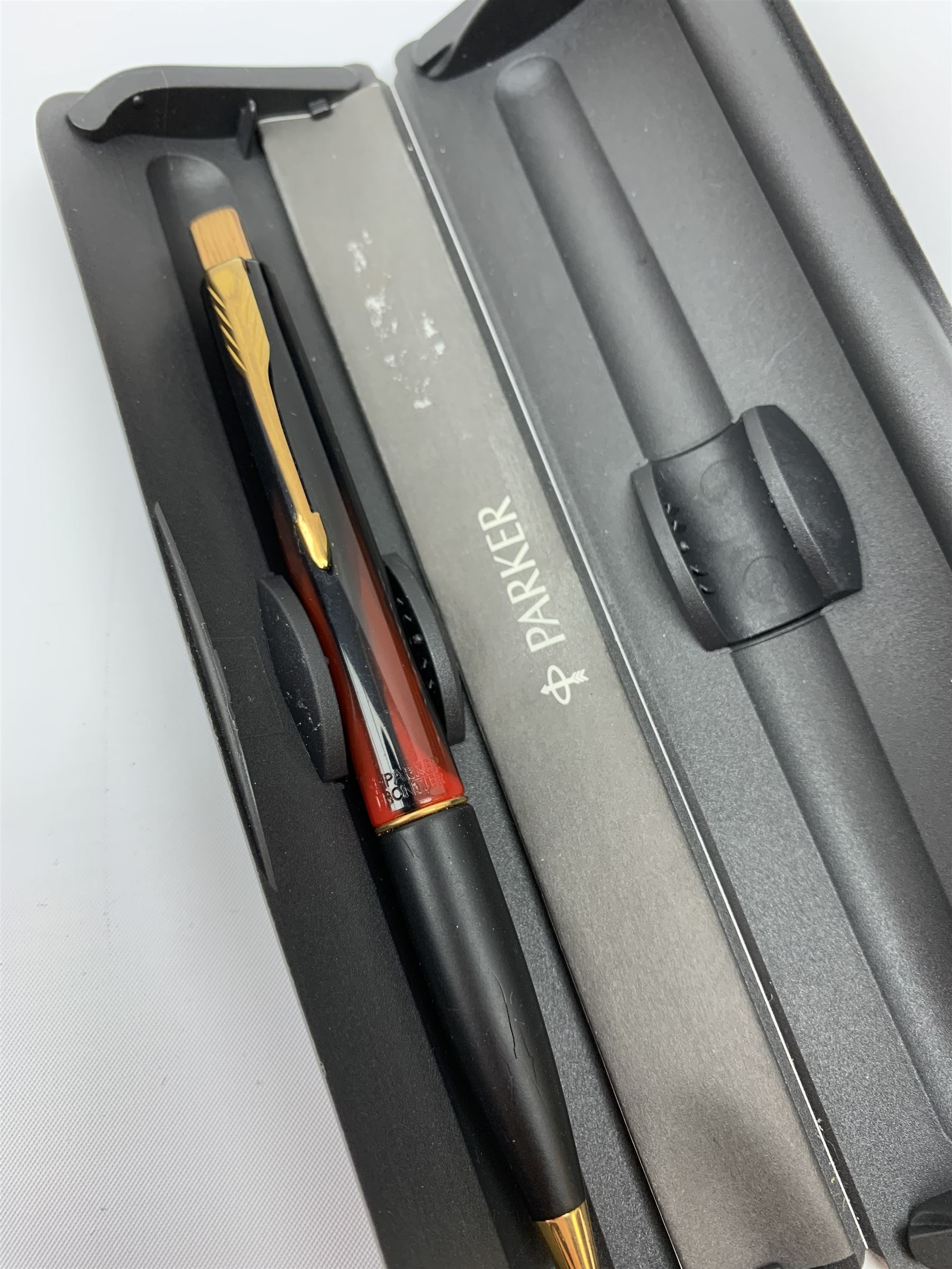 A group of pens, comprising Parker Duofold Centennial pearl and black ballpoint pen, Parker Frontier ballpoint pen, Ronson Penciliter, in original box, Parker Rialto fountain pen, and a further unmarked ballpoint. (5). 