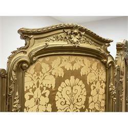 Late 19th/early 20th century French Rococo style gilt wood and gesso dressing screen, four double hinged panels, each with shaped cresting rail over shell and floral frieze, moulded frame with flower head and scroll decoration, acanthus leaf cabriole supports with castors, upholstered in gold Damask fabric