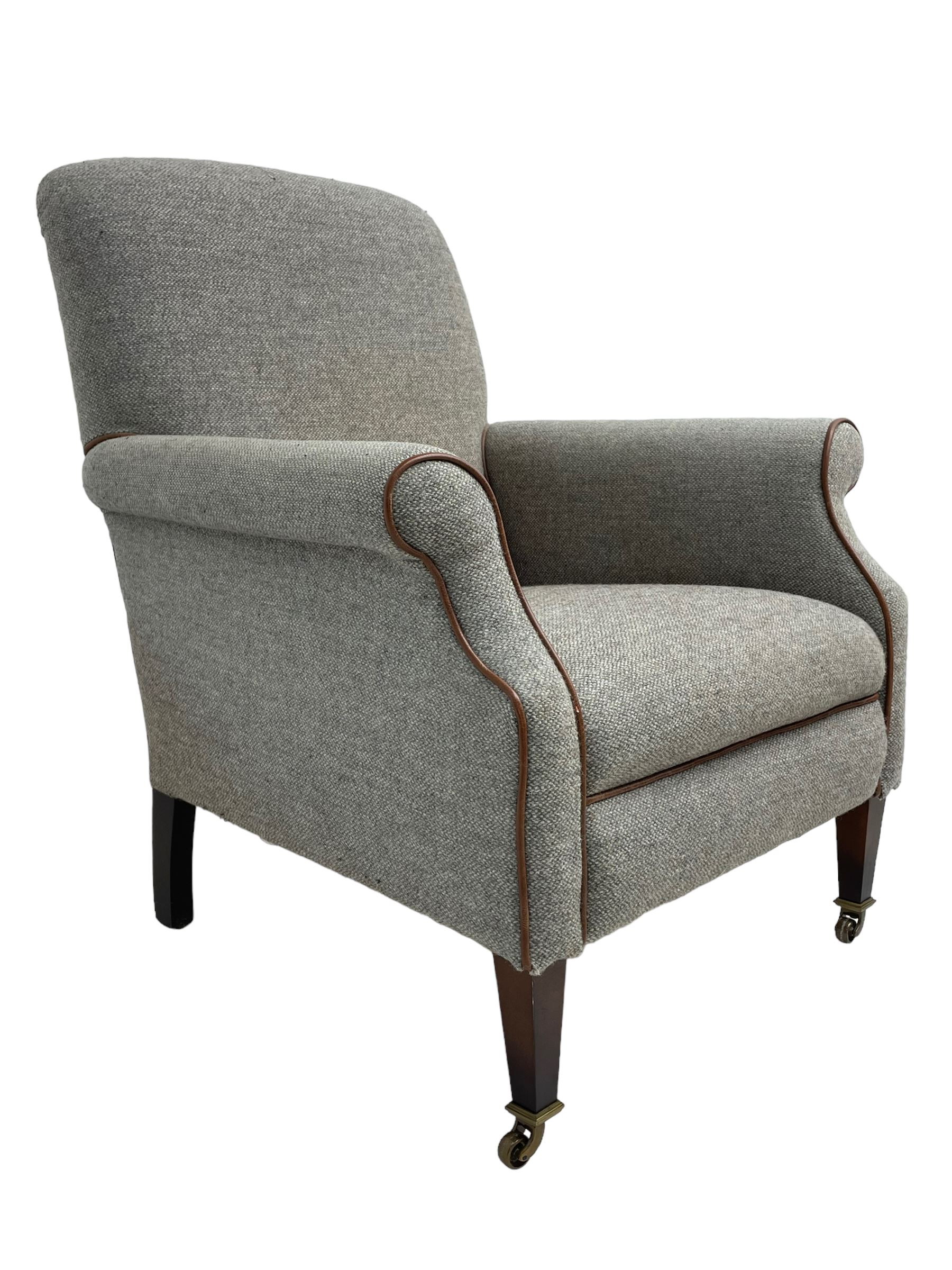 Interiors at Nine to Eleven - Edwardian design armchair, traditional shape with rolled arms, upholstered in 'Harris Tweed' fabric with leather piping, raised on square taping supports with castors
