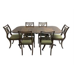 Regency design mahogany twin pedestal dining table, rectangular top with reeded edge, acanthus carved turned column terminating in reeded tripod base with hairy paw feet and castors (W172cm D92cm H75cm) and set eight (6+2) Regency design mahogany dining chairs, pierced back with scroll design, seat upholstered in patterned laurel green fabric, raised on reeded sabre supports (W48cm H88cm)