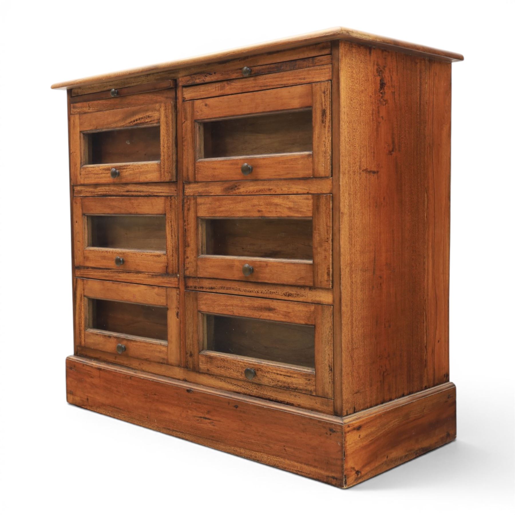 20th century Haberdashery style hardwood chest, two brushing slides, with six glass fronted drawers, blackened metal pulls, plinth base 