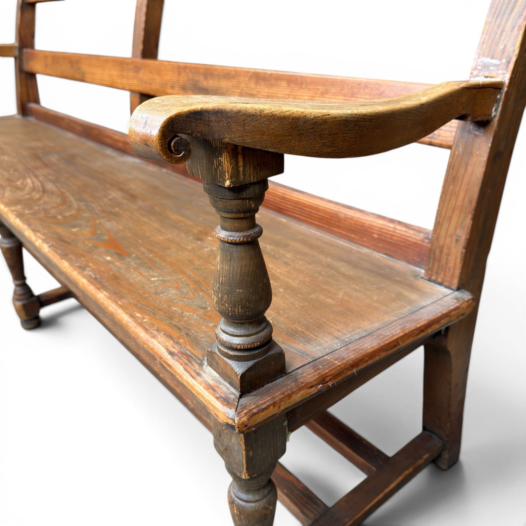 Early 20th century pine and oak bench seat, stained pine rail back frame with shaped oak arms