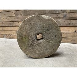 19th century circular stone mill wheel,