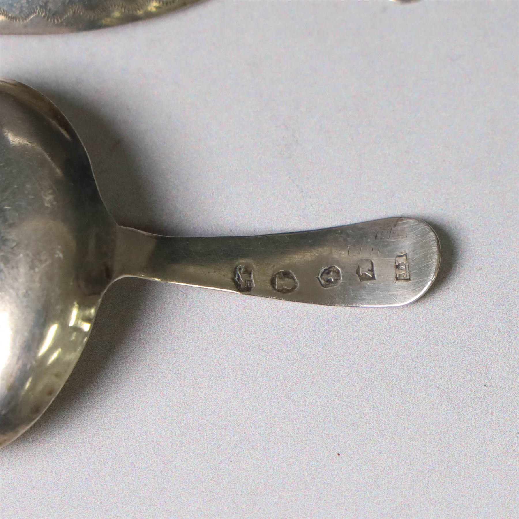 Two George III silver caddy spoons, the first example with oval bowl and flat handle with engraved initial, hallmarked Birmingham 1796, makers mark probably IT, the second with oval bowl, curved handle with shield and initial engraving, hallmarked George Smith III, London 1783