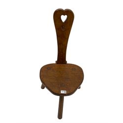 Acornman - adzed oak spinning chair, spoon shaped back with pierced heart and acorn signature, spade-shaped seat raised on octagonal tapering supports by Alan Grainger of Brandsby
