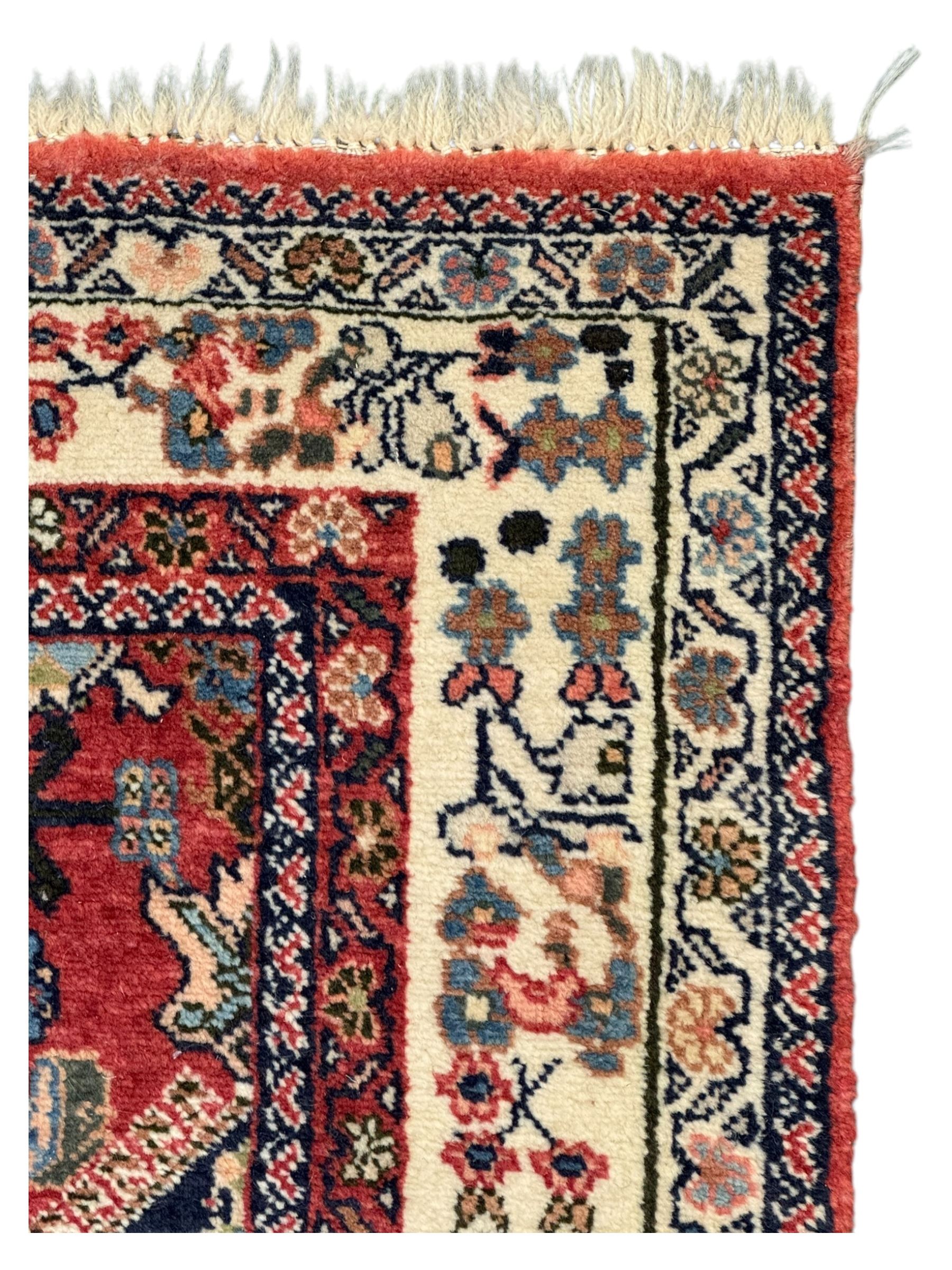 Pair of rugs one Persian hamadan rug central stepped medallion enclosing geometric motifs in ivory and brown, framed by a cream border with scrolling palmettes and fringed ends (H 156cm W 105cm), one Pakistani Bokhara rug rust red ground with repeated Tekke gul motifs within rosette and lozenged borders, fringed ends (H 98cm, W 65cm)