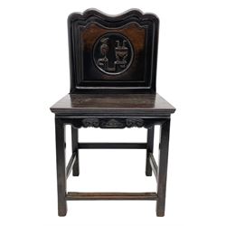 Early 20th century Chinese hardwood side chair, the shaped panelled back carved with circular motif depicting precious objects, the seat rail carved with scrolls and flower head, square supports joined by plain stretchers 