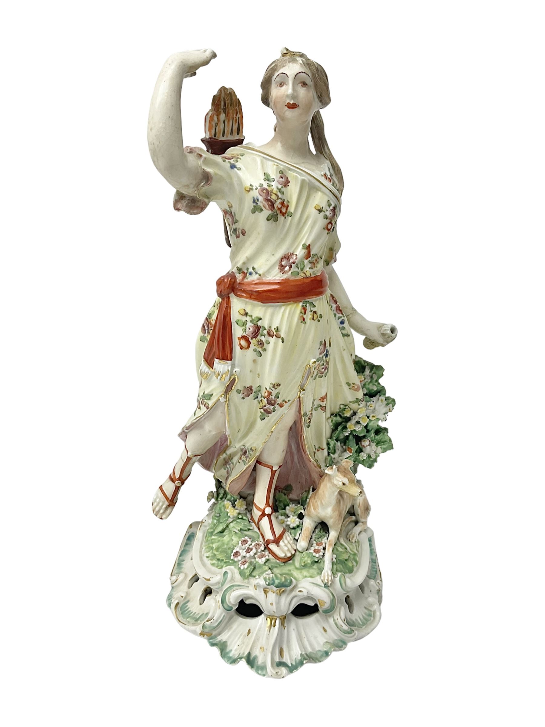 18th century Derby figure of Diana the huntress, circa 1760, modelled reaching for an arrow from quiver across her back, with recumbent hound at her feet, upon a scrolled base with bocage detail, H27.5cm