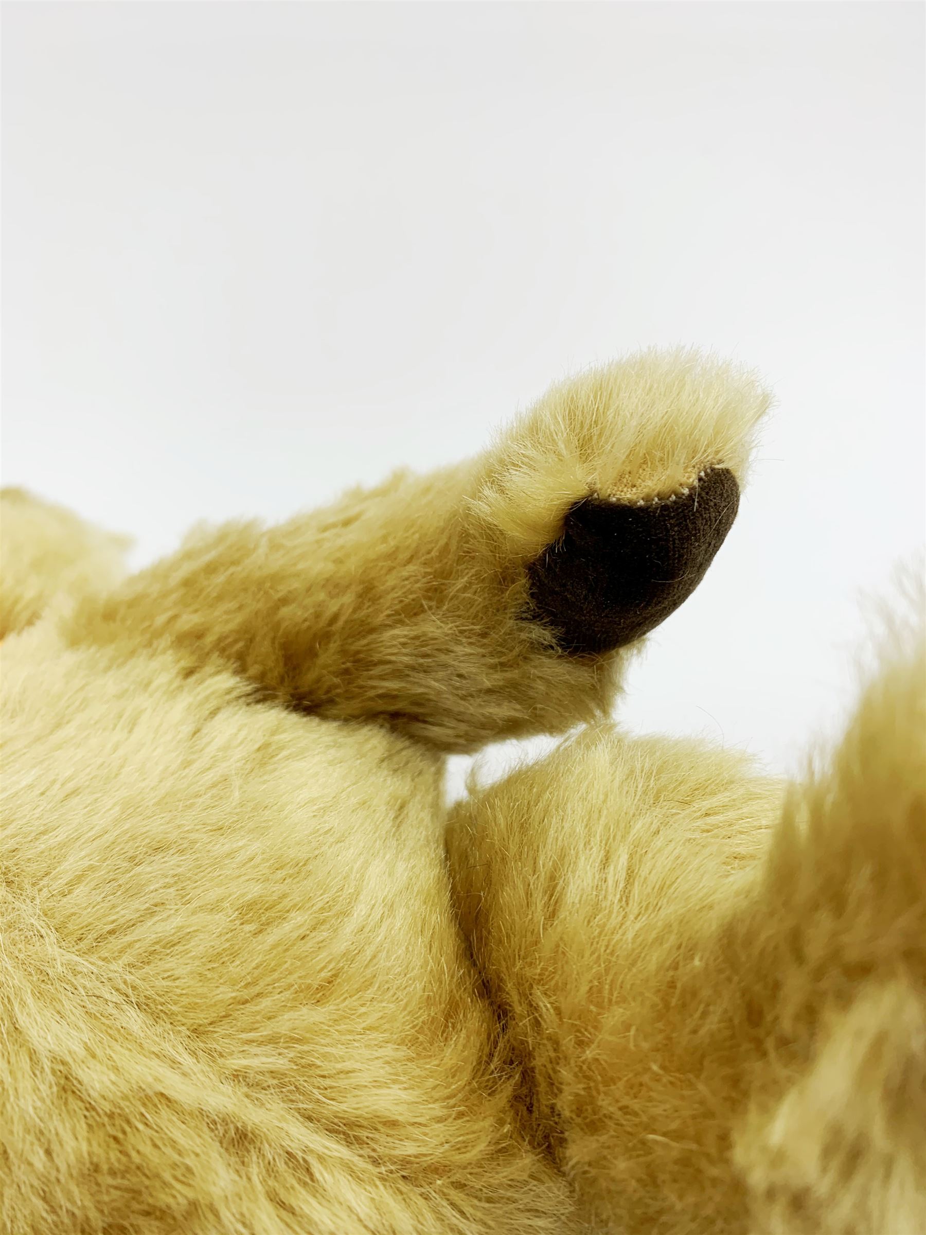 Chad Valley Hygienic Toys teddy bear c1950, kapok filled mohair plush body with original factory given yellow neck ribbon, jointed limbs with velvet paw pads, glass eyes and vertically stitched nose and mouth, blue/white printed label to side seam H12